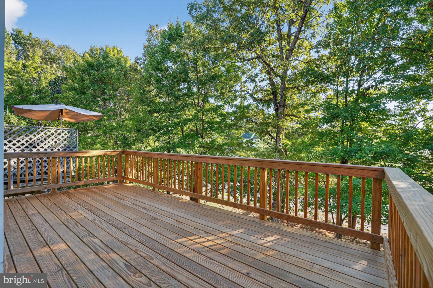 6836 Kerrywood Circle Centreville, VA 20121 - Photo 21 of 22 a balcony with wooden floor and trees in the back