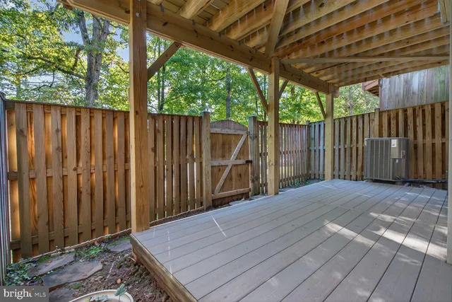 a view of a backyard with wooden fence