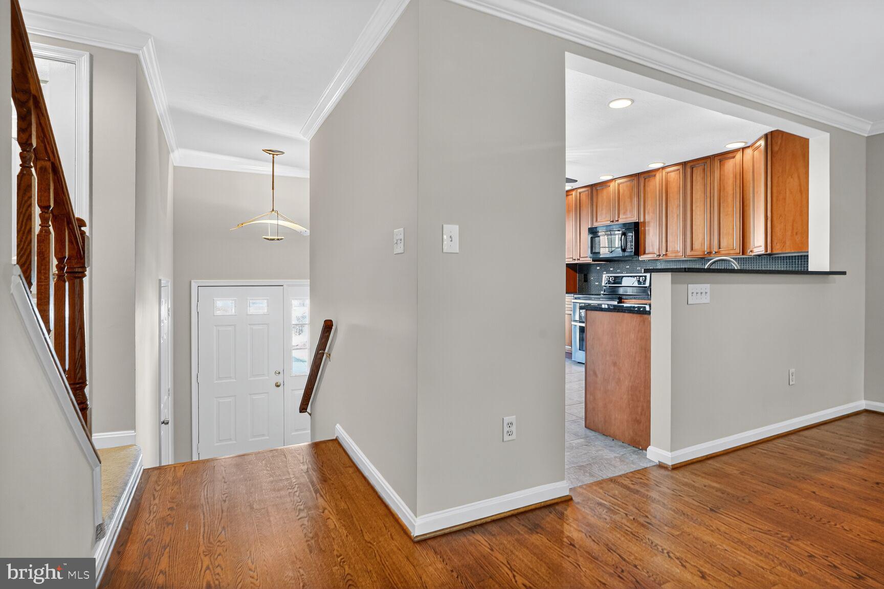 6836 Kerrywood Circle Centreville, VA 20121 - Photo 3 of 22 a view of empty room with wooden floor and fan