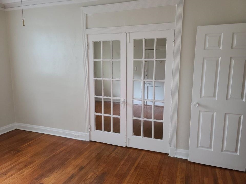 244 South Cleveland Street Memphis, TN 38104 - Photo 1 of 8 an empty room with wooden floor and windows