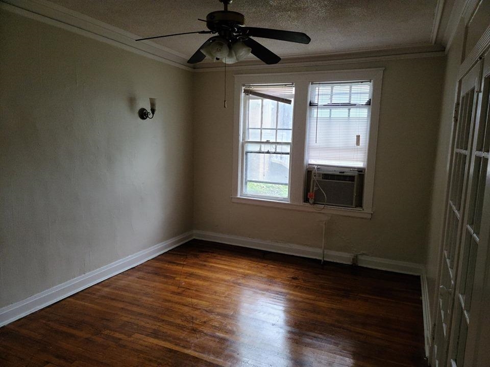 244 South Cleveland Street Memphis, TN 38104 - Photo 3 of 8 a view of empty room with wooden floor and fan