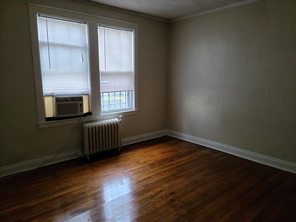 244 South Cleveland Street Memphis, TN 38104 - Photo 5 of 8 a view of an empty room with wooden floor and a window