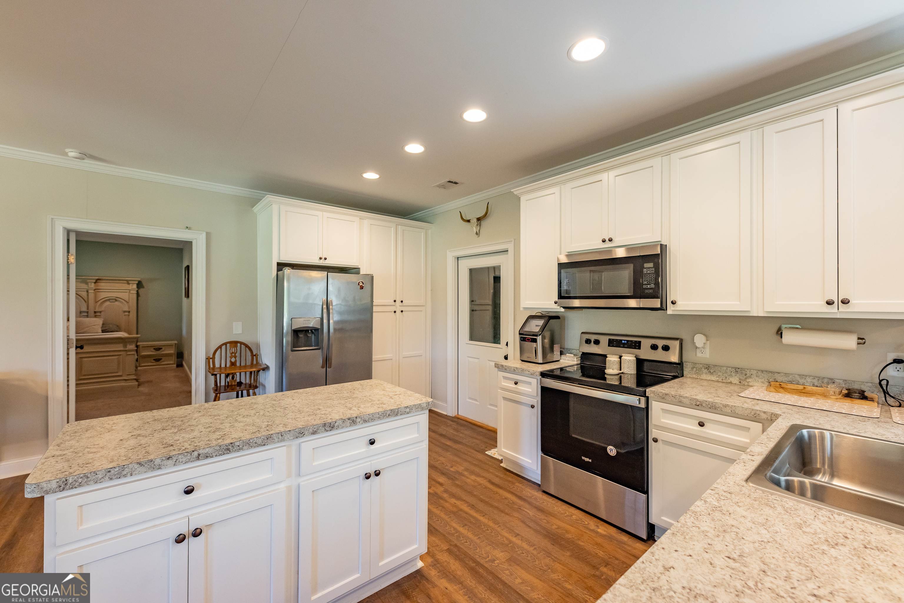 1730 Roland Road Thomaston, GA 30286 - Photo 11 of 55 a kitchen with stainless steel appliances granite countertop a stove a sink and a refrigerator