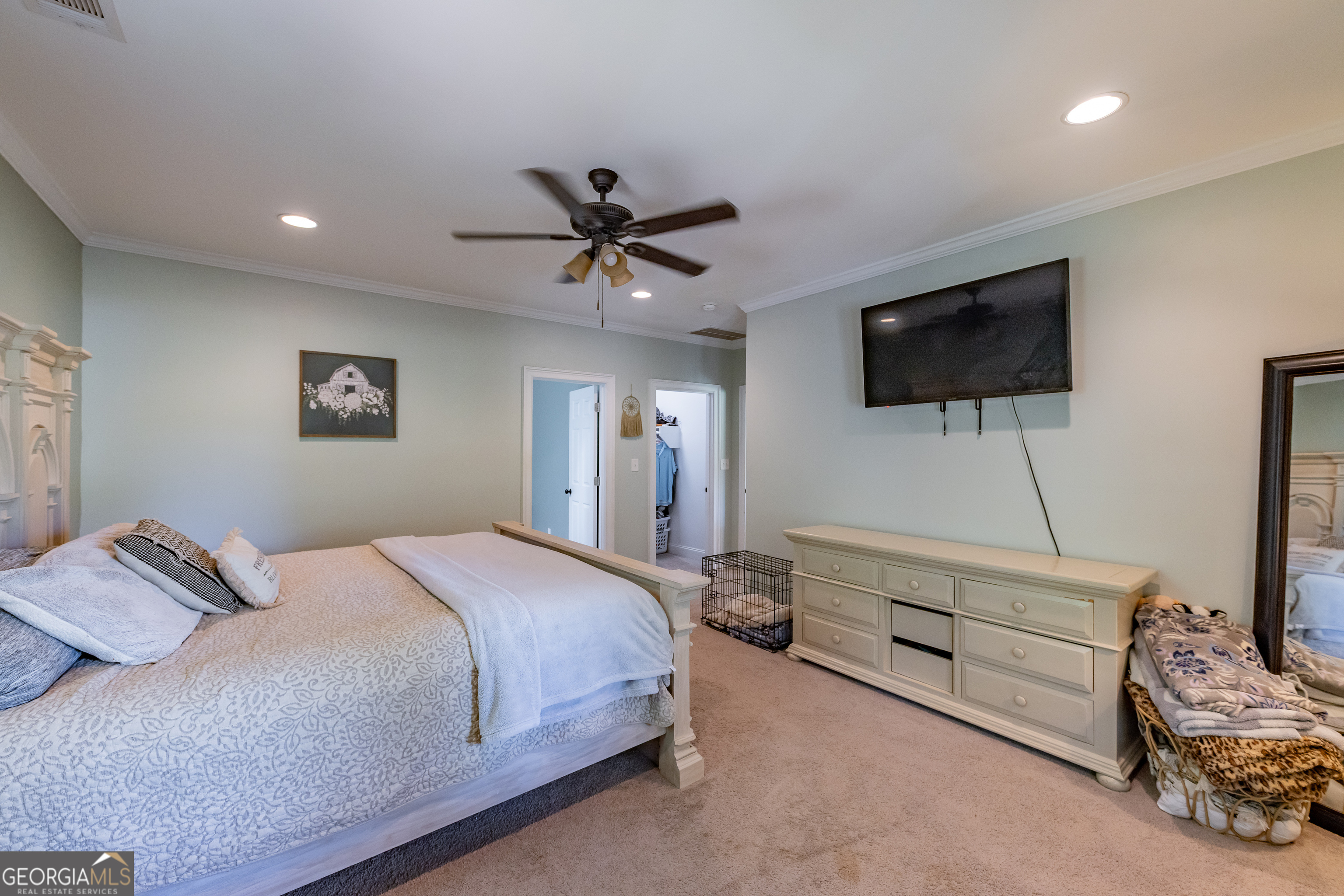 1730 Roland Road Thomaston, GA 30286 - Photo 13 of 55 a bedroom with a bed a mirror and a flat screen tv