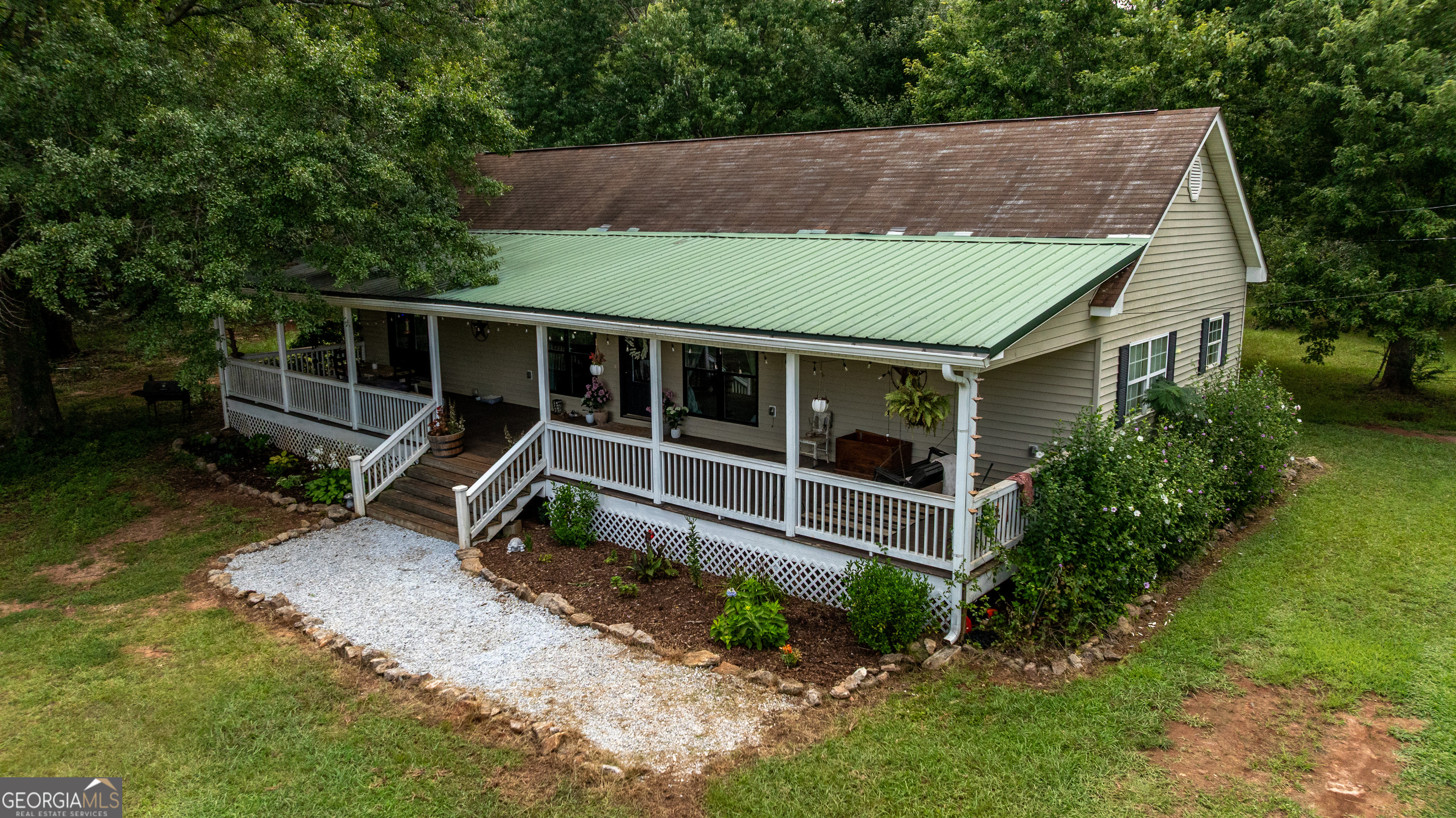 1730 Roland Road Thomaston, GA 30286 - Photo 2 of 55 an aerial view of a house with a yard table and chairs