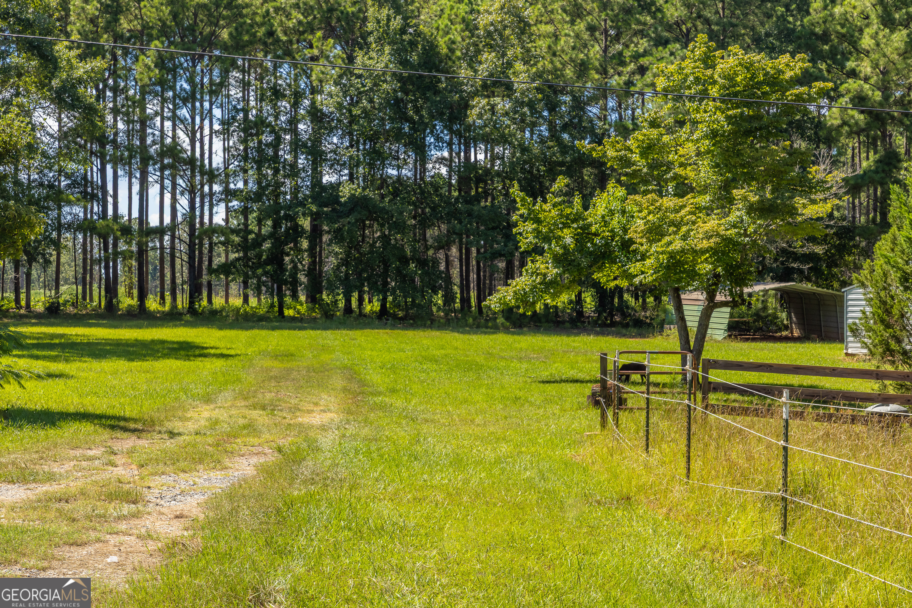 1730 Roland Road Thomaston, GA 30286 - Photo 22 of 55 a swimming pool with outdoor seating and yard