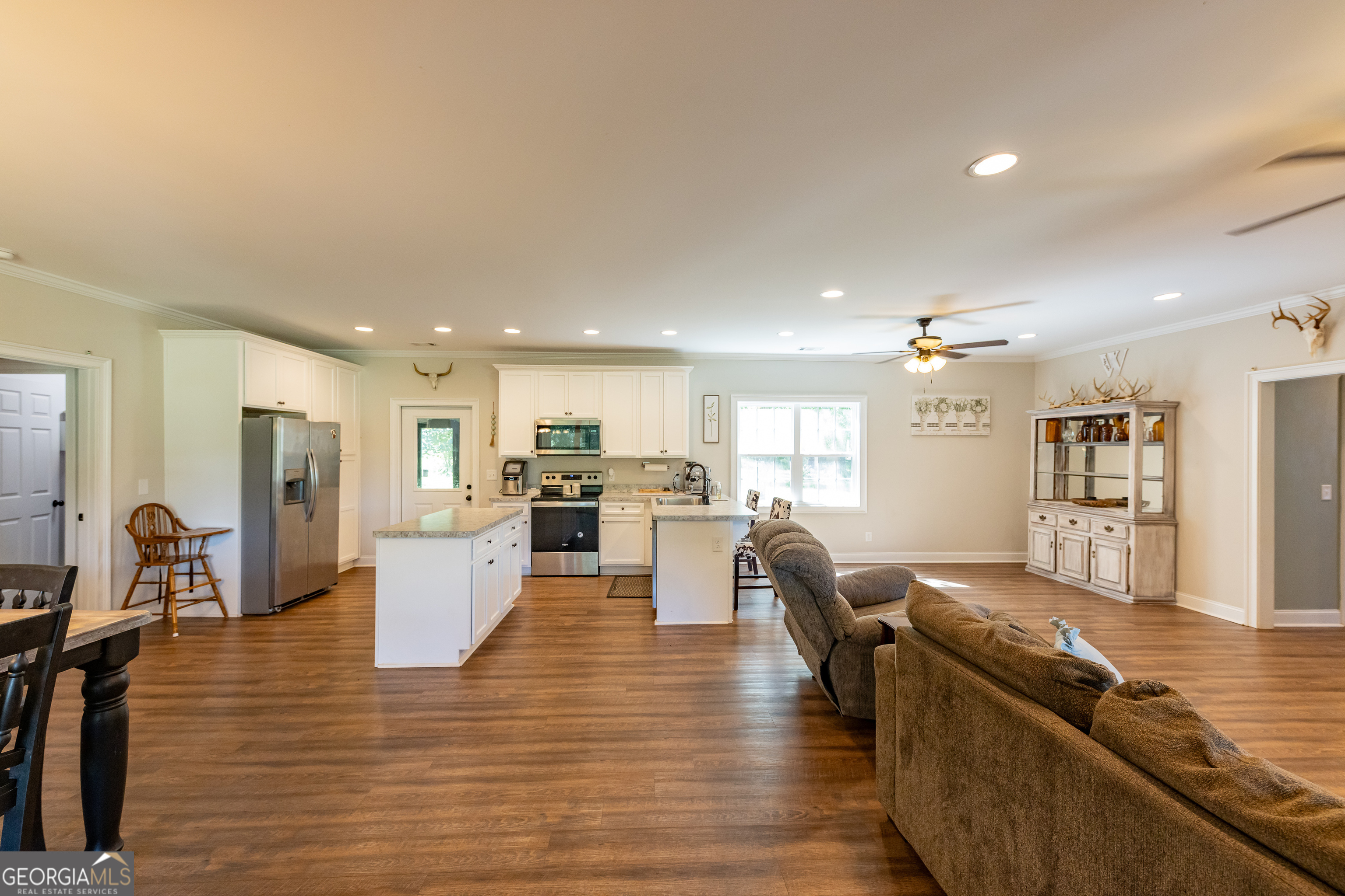 1730 Roland Road Thomaston, GA 30286 - Photo 9 of 55 a living room with couches and kitchen view with wooden floor