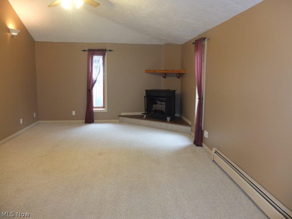 1244 Ridge Road Northwest Canton, OH 44703 - Photo 3 of 21 Family room with fireplace, vaulted ceiling and skylight.