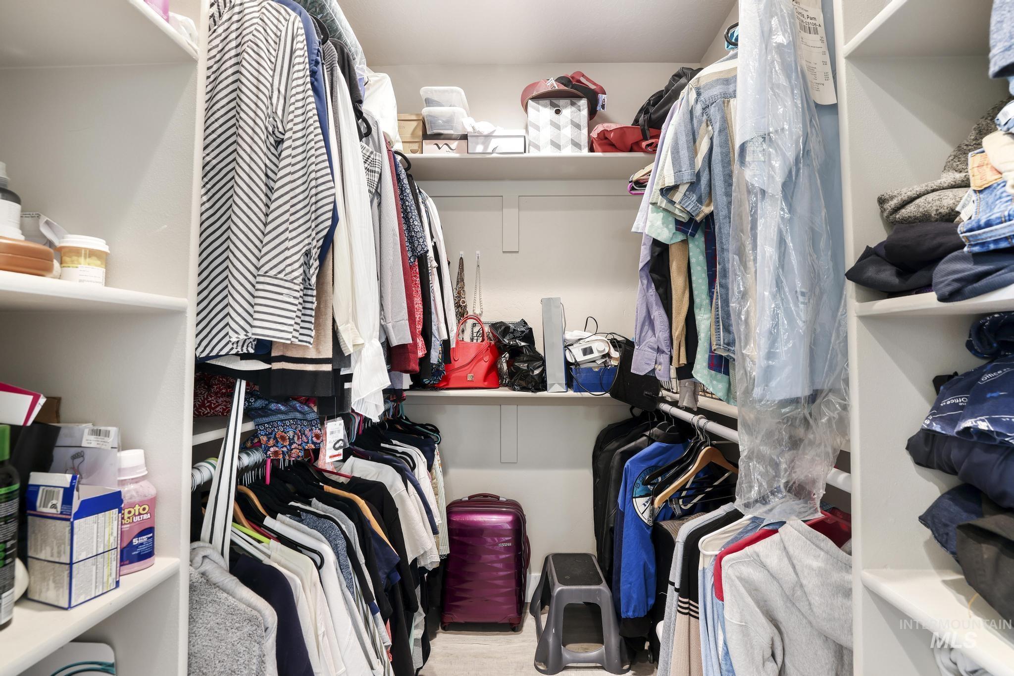 758 Cedar Crk Road Rogerson, ID 83302 - Photo 23 of 50 Walk-in closet featuring white built-in shelving, multiple hanging rods, and ample storage capacity