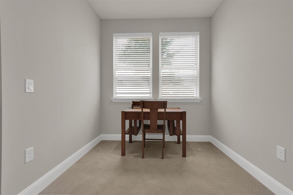 651 Watters Road, Unit 2105 Allen, TX 75013 - Photo 18 of 32 a dining room with a table and chairs