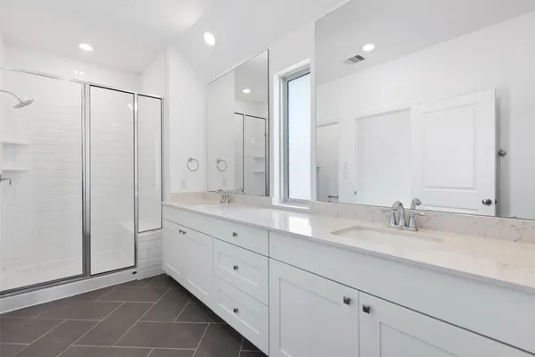 a bathroom with double sink and a mirror