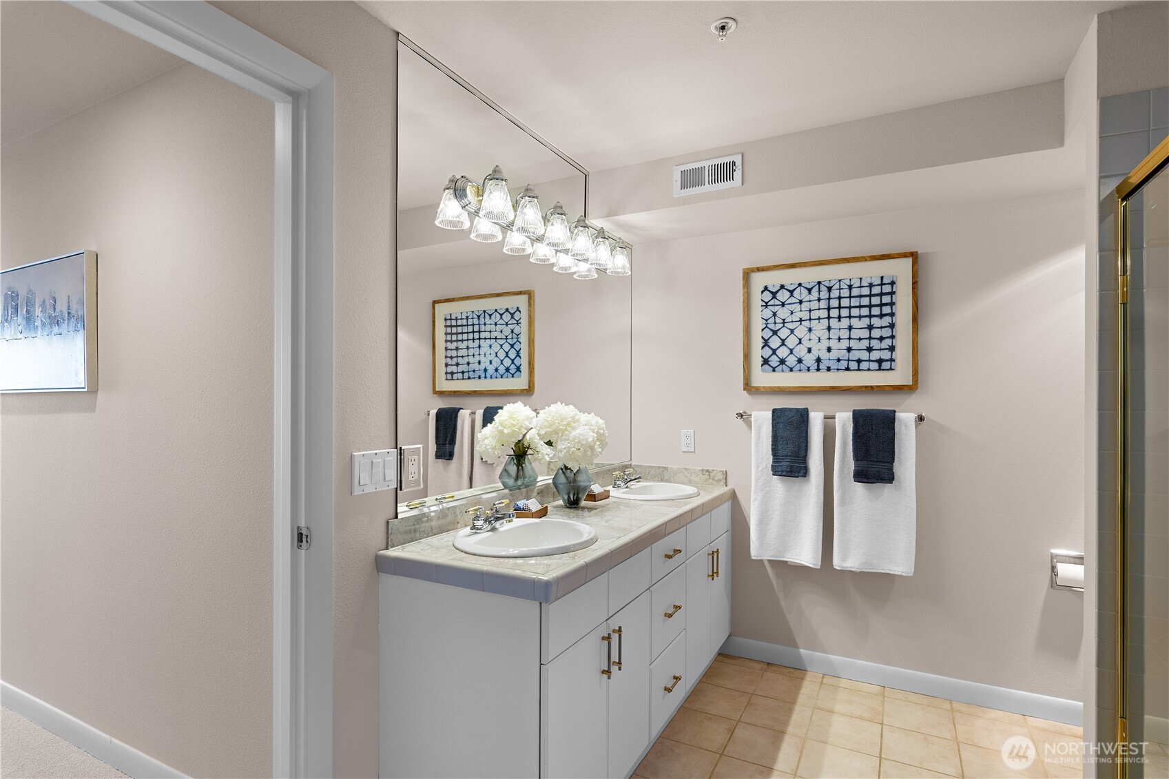 1300 Alki Avenue Southwest, Unit 200 Seattle, WA 98116 - Photo 21 of 32 a bathroom with a sink a mirror and a shower