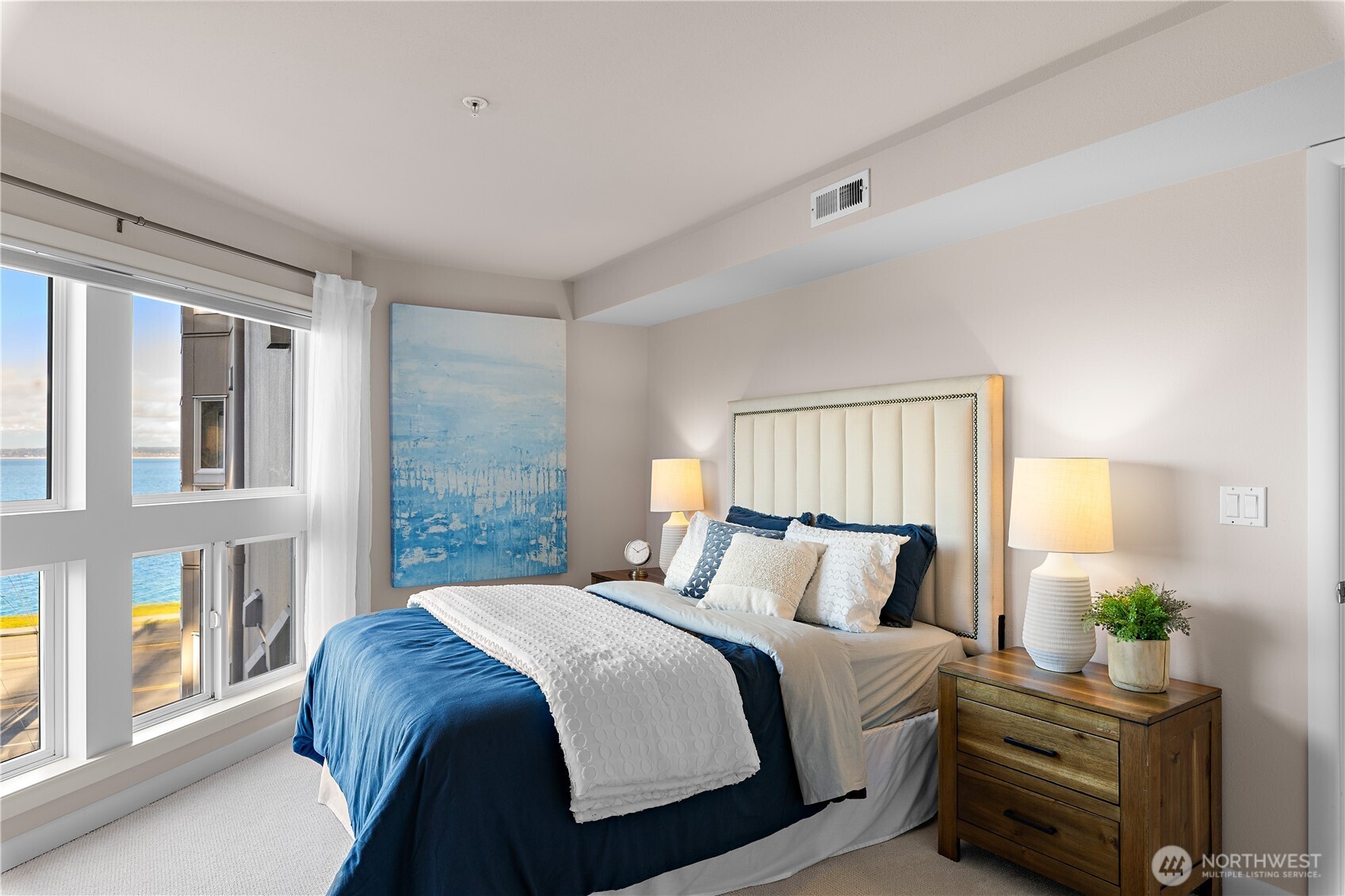 1300 Alki Avenue Southwest, Unit 200 Seattle, WA 98116 - Photo 23 of 32 a bedroom with a balcony a bed and a window