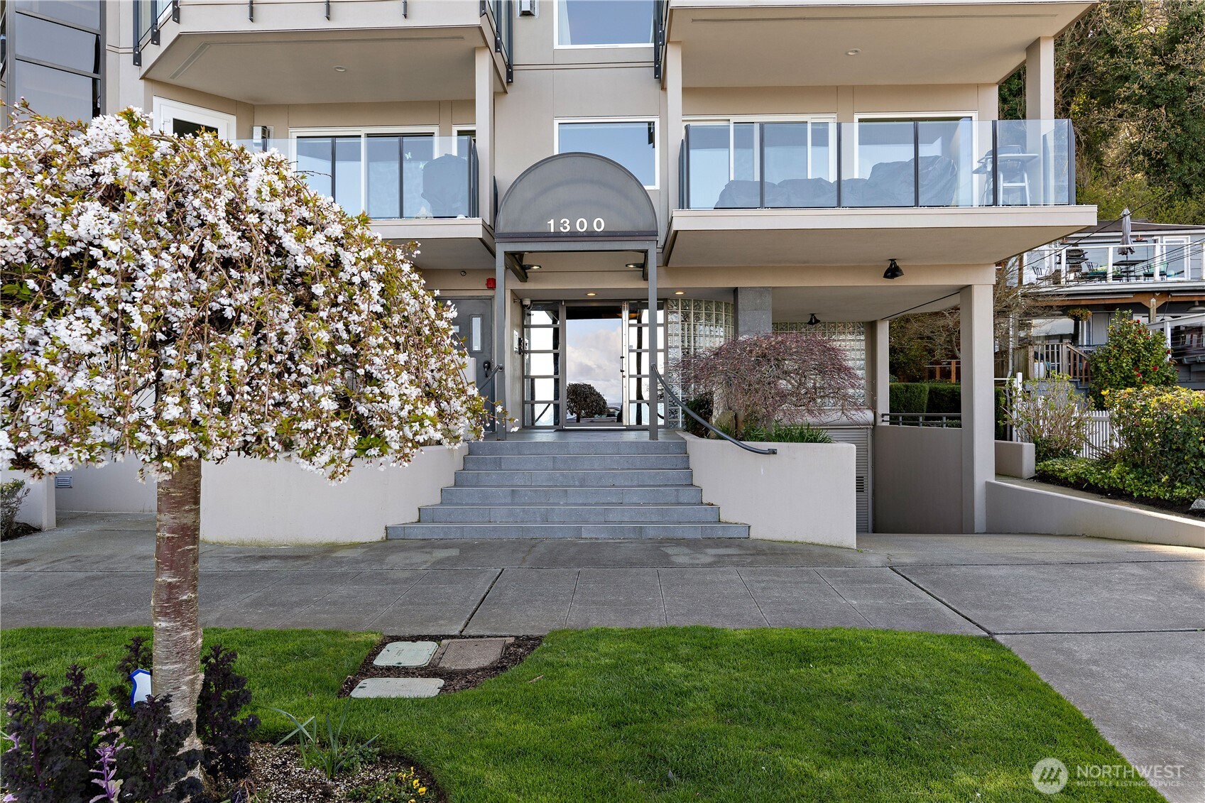1300 Alki Avenue Southwest, Unit 200 Seattle, WA 98116 - Photo 29 of 32 a front view of a house with a yard and potted plants