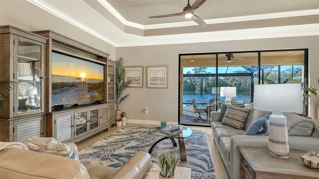 5914 Cessna Run Lakewood Ranch, FL 34211 - Photo 11 of 92 a living room with furniture and a flat screen tv