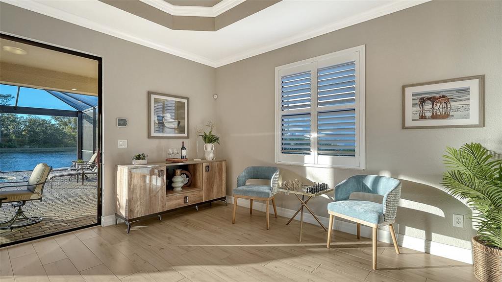 5914 Cessna Run Lakewood Ranch, FL 34211 - Photo 13 of 92 a living room with furniture a window and a table