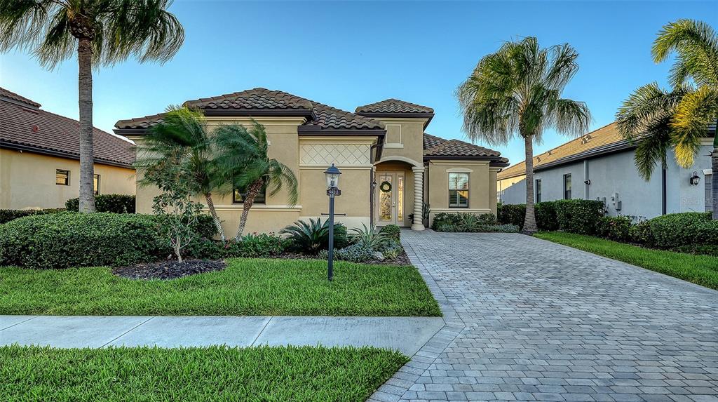 5914 Cessna Run Lakewood Ranch, FL 34211 - Photo 2 of 92 a front view of a house with a garden