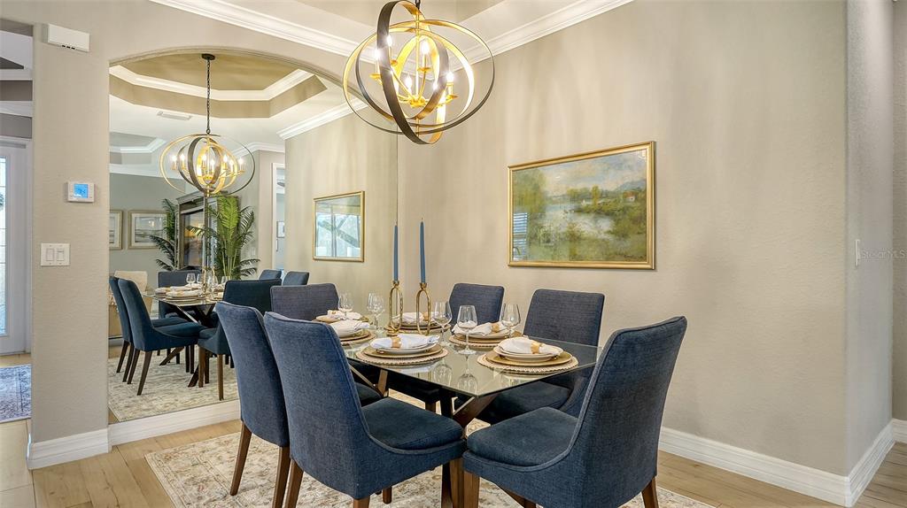 5914 Cessna Run Lakewood Ranch, FL 34211 - Photo 23 of 92 a view of a dining room with furniture window and wooden floor