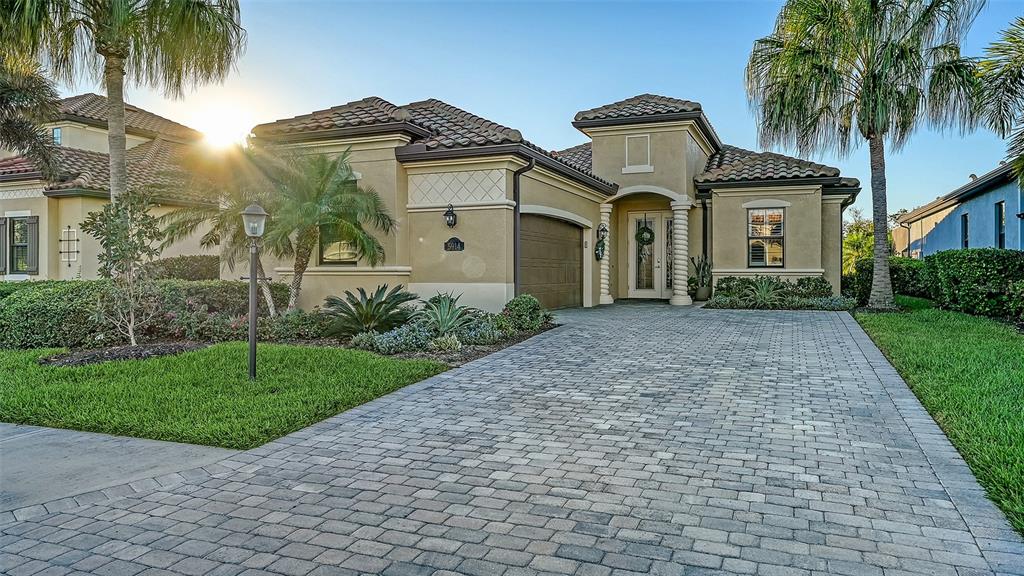 5914 Cessna Run Lakewood Ranch, FL 34211 - Photo 3 of 92 a front view of a house with a yard and garage