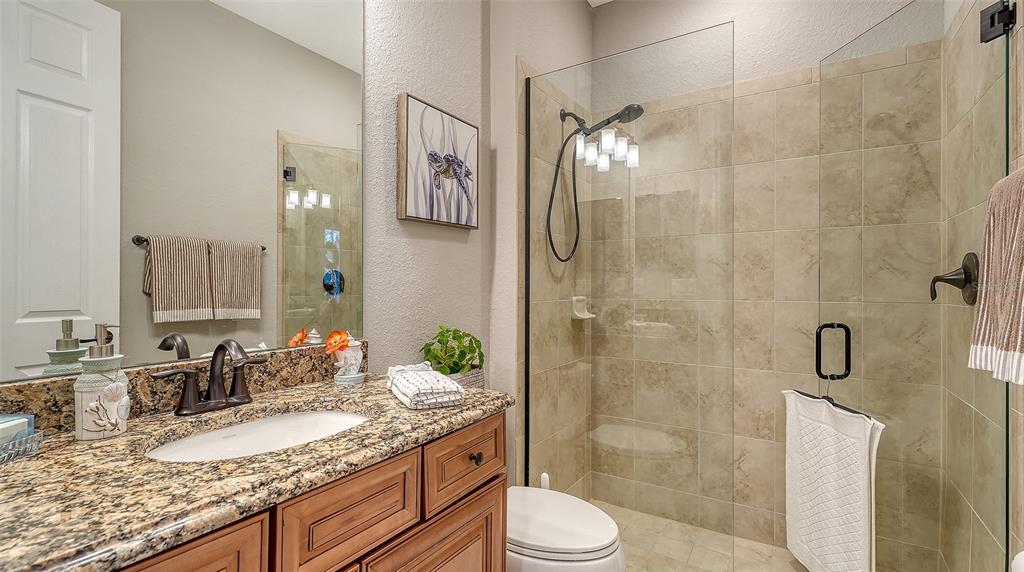 5914 Cessna Run Lakewood Ranch, FL 34211 - Photo 36 of 92 a bathroom with a granite countertop sink toilet and shower