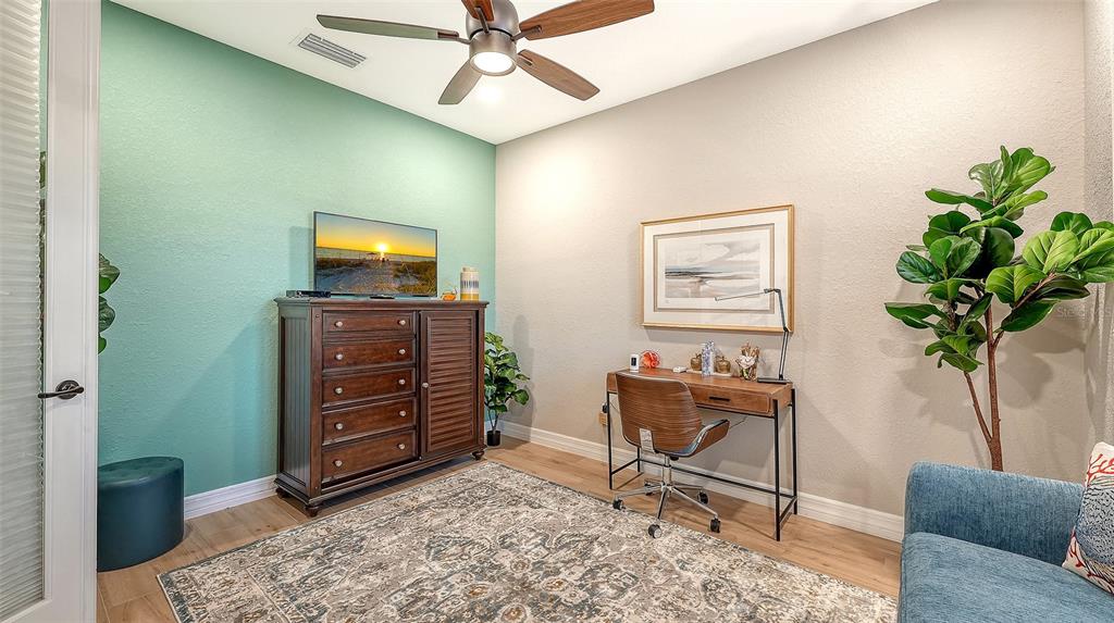 5914 Cessna Run Lakewood Ranch, FL 34211 - Photo 39 of 92 a living room with furniture and a potted plant