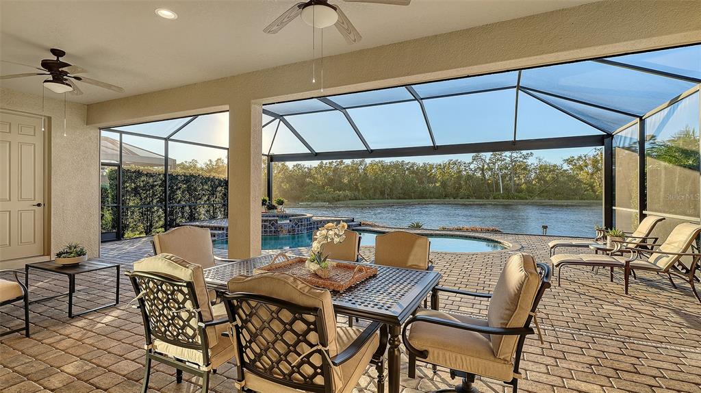 5914 Cessna Run Lakewood Ranch, FL 34211 - Photo 41 of 92 a view of a patio with a table and chairs under an umbrella