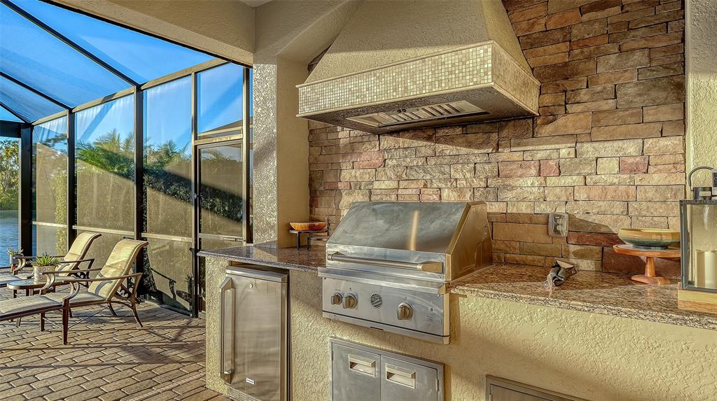 5914 Cessna Run Lakewood Ranch, FL 34211 - Photo 44 of 92 a kitchen with a stove and a view of the front door