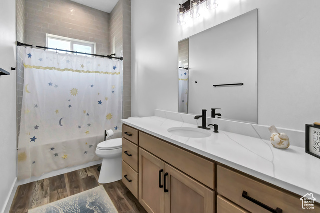 1952 Highway 118 Monroe, UT 84754 - Photo 42 of 88 Full bath featuring vanity, wood finished floors, and shower / tub combo with curtain