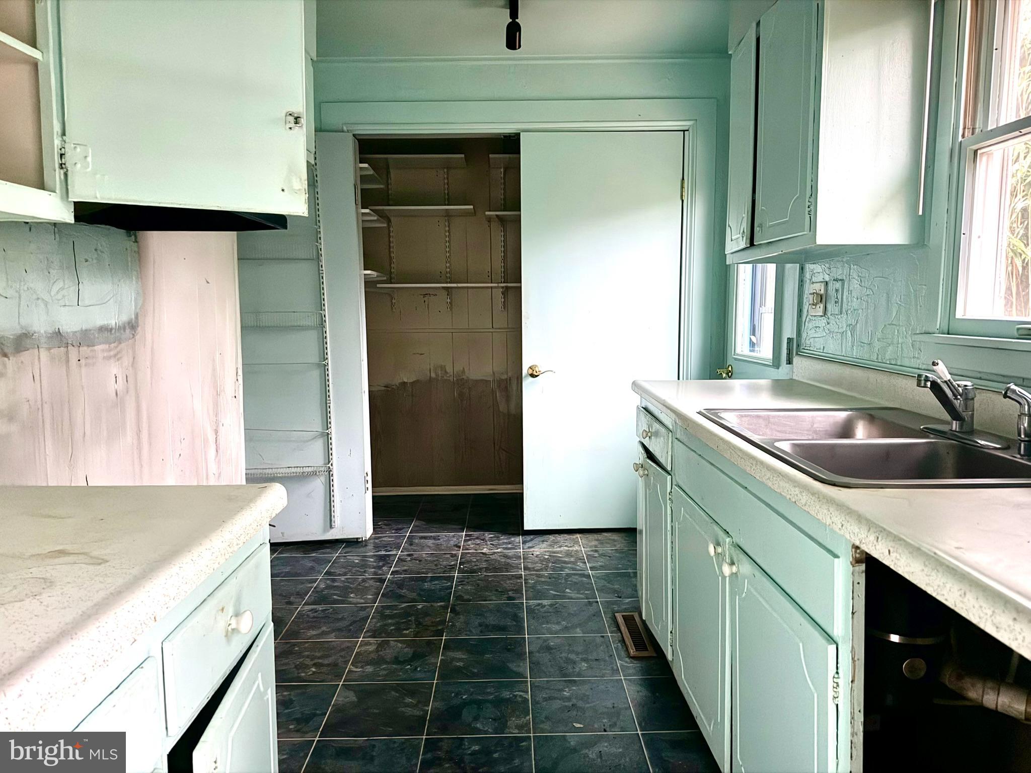 112 Strawberry Way Rehoboth Beach, DE 19971 - Photo 6 of 14 a kitchen with a sink and a refrigerator