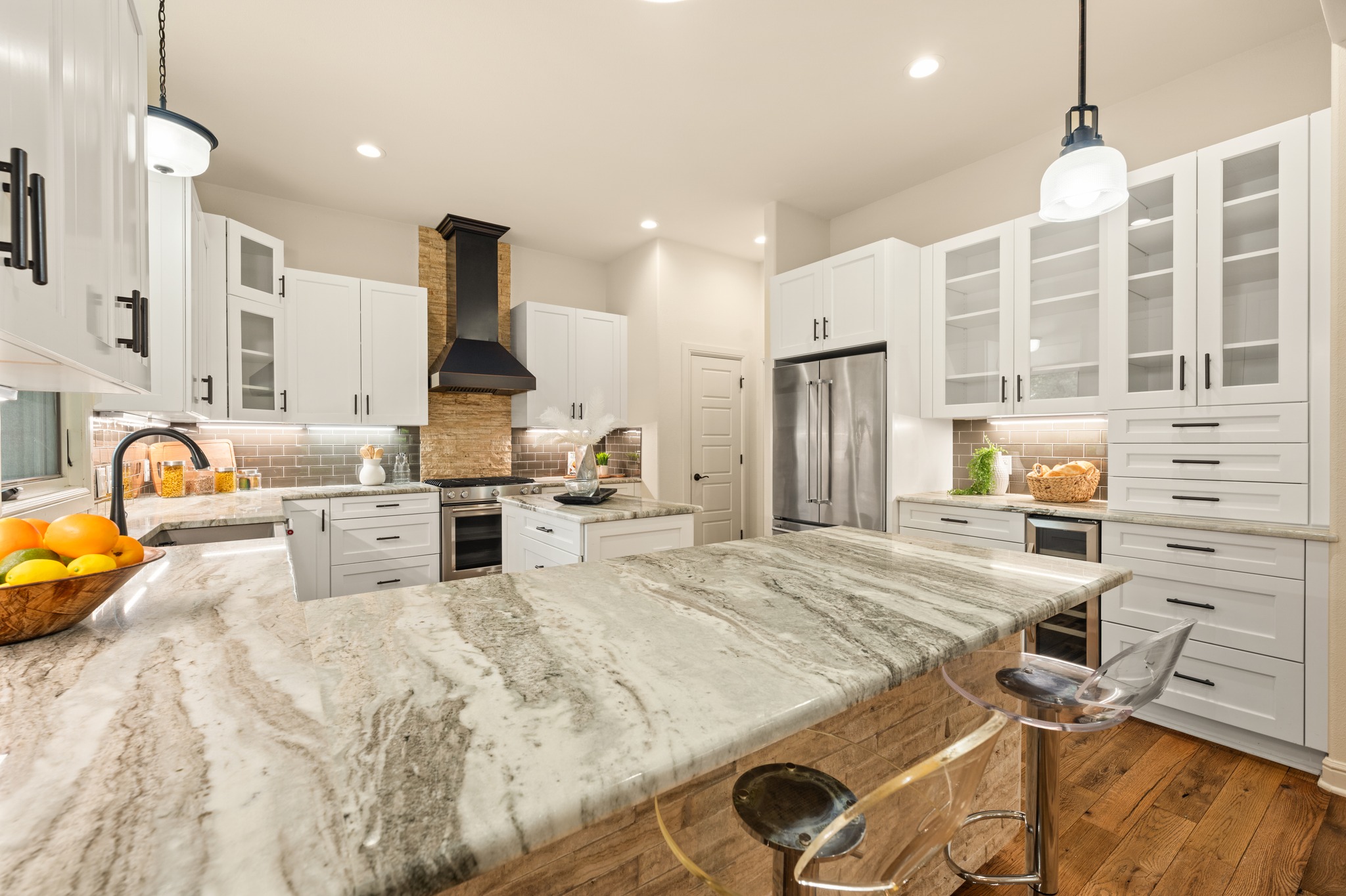 3907 Bailey Lane Austin, TX 78756 - Photo 4 of 40 The contrast of the granite countertops compliment the subway tile backsplash and white, soft-close cabinetry