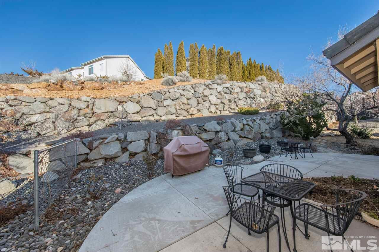 1184 University Ridge Drive Reno, NV 89512 - Photo 23 of 25 a view of a chairs and table in backyard