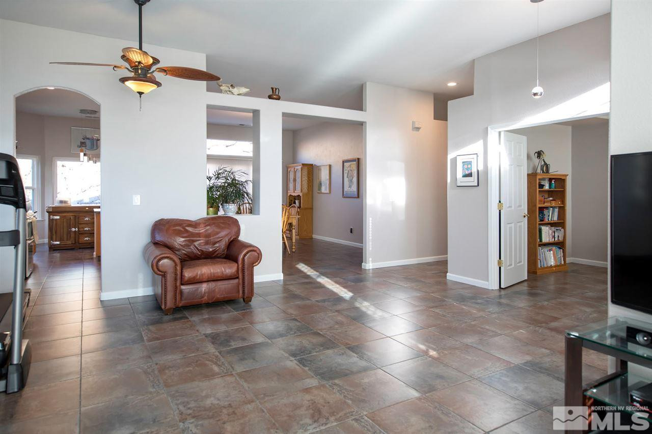 1184 University Ridge Drive Reno, NV 89512 - Photo 3 of 25 a living room with furniture a dining table and chairs