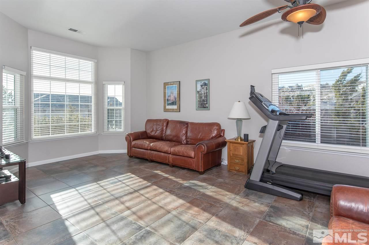 1184 University Ridge Drive Reno, NV 89512 - Photo 4 of 25 a living room with furniture and a floor to ceiling window