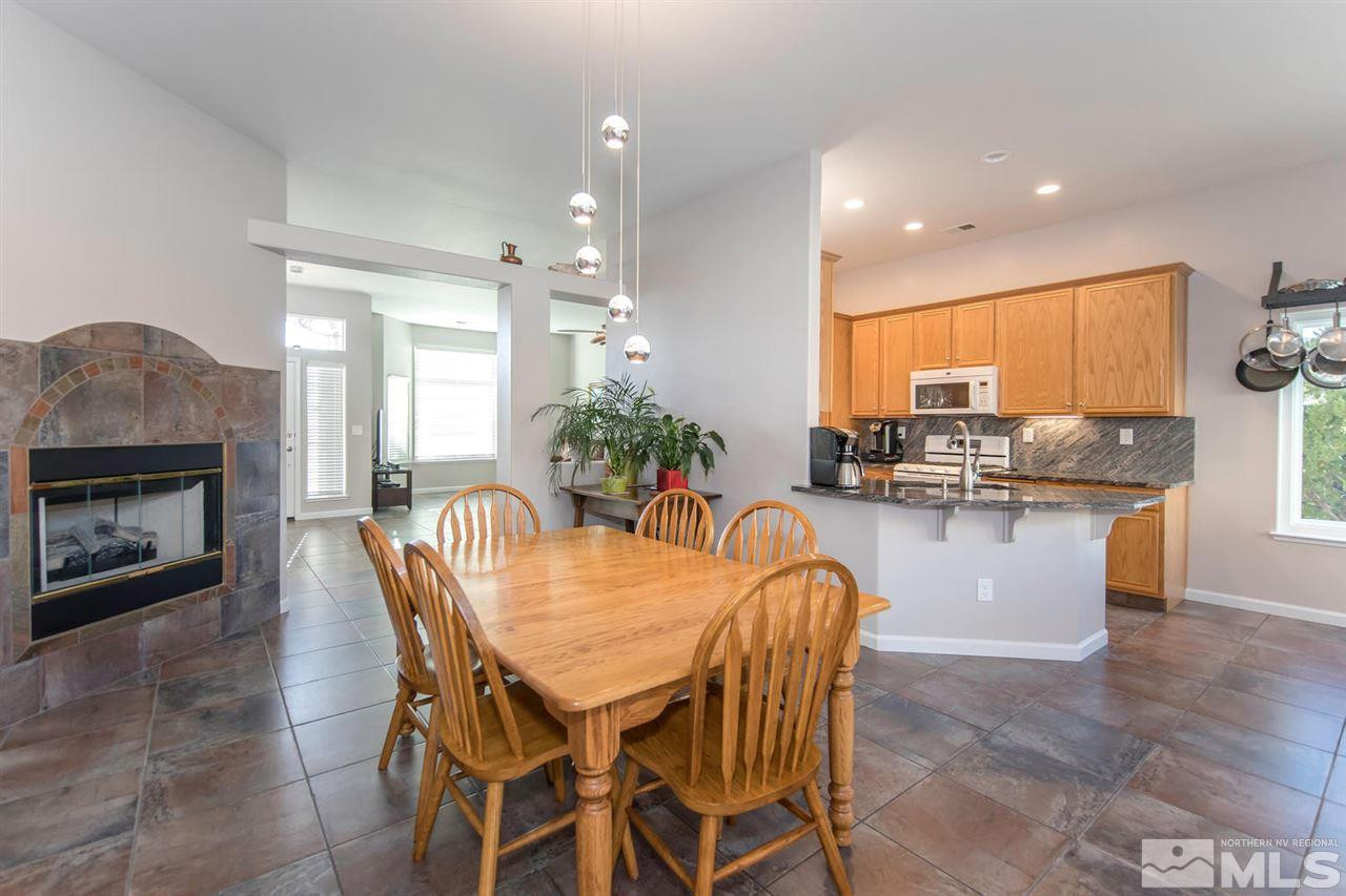1184 University Ridge Drive Reno, NV 89512 - Photo 6 of 25 a dining room with furniture a window and kitchen view