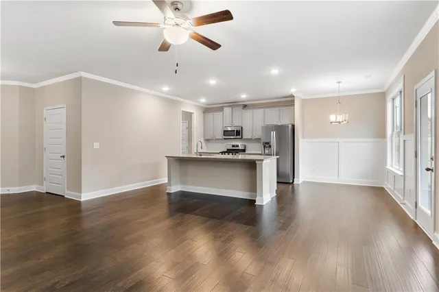 a view of kitchen with refrigerator and wooden floor