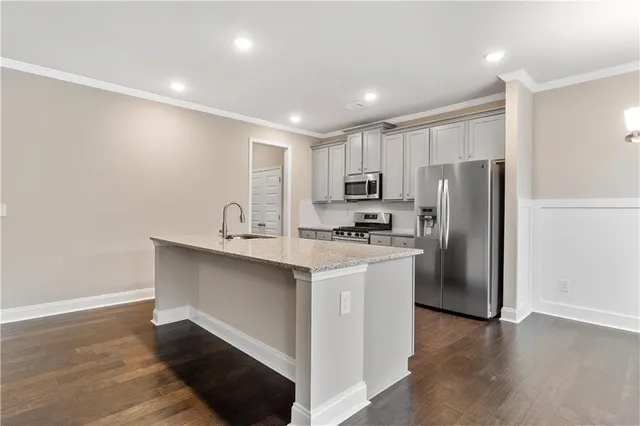a kitchen with refrigerator cabinets and wooden floor
