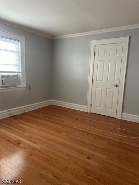 75 Monticello Avenue Newark, NJ 07106 - Photo 3 of 3 a view of empty room with wooden floor and fan