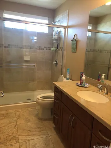 a bathroom with a double vanity sink toilet and shower