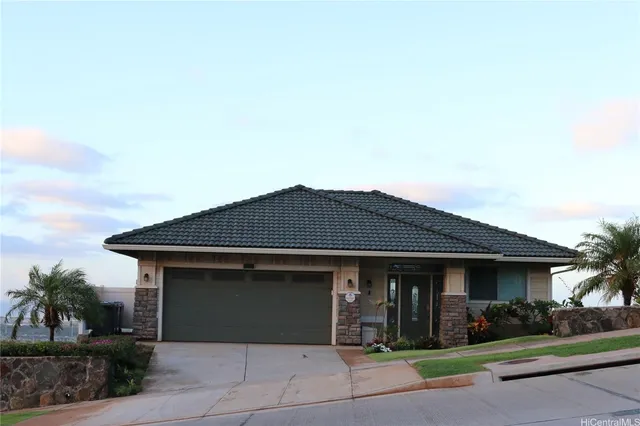 a front view of a house with a yard and garage