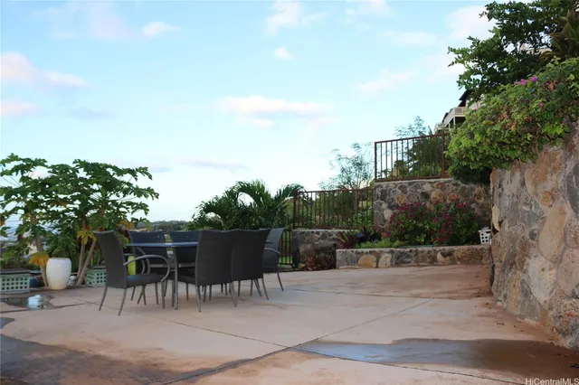 a view of backyard with seating and green space