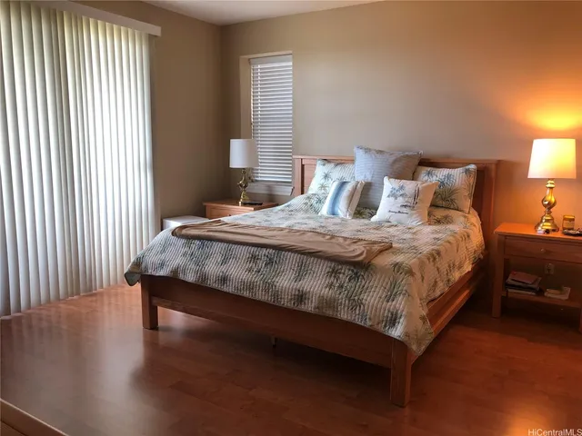 a bedroom with a bed and a night stand