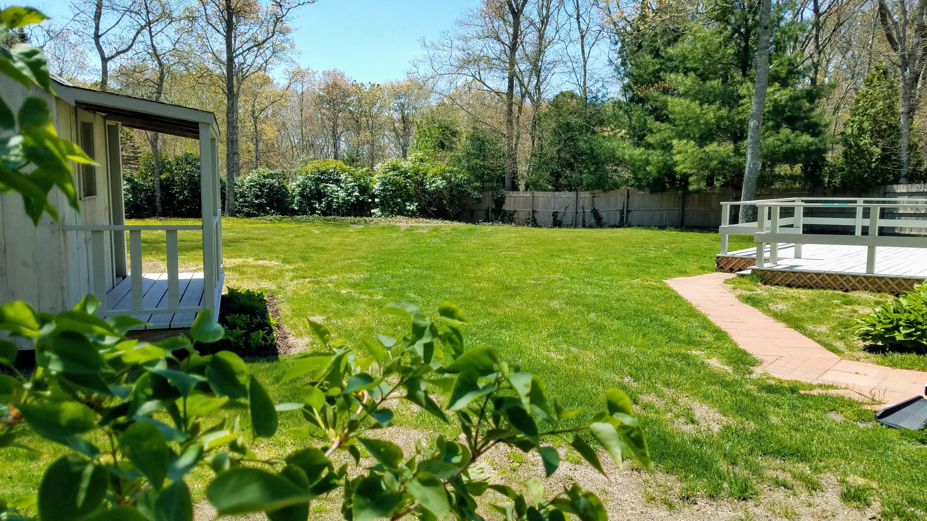 43 Valley Brook Road Centerville, MA 02632 - Photo 16 of 21 a view of a garden with a large tree