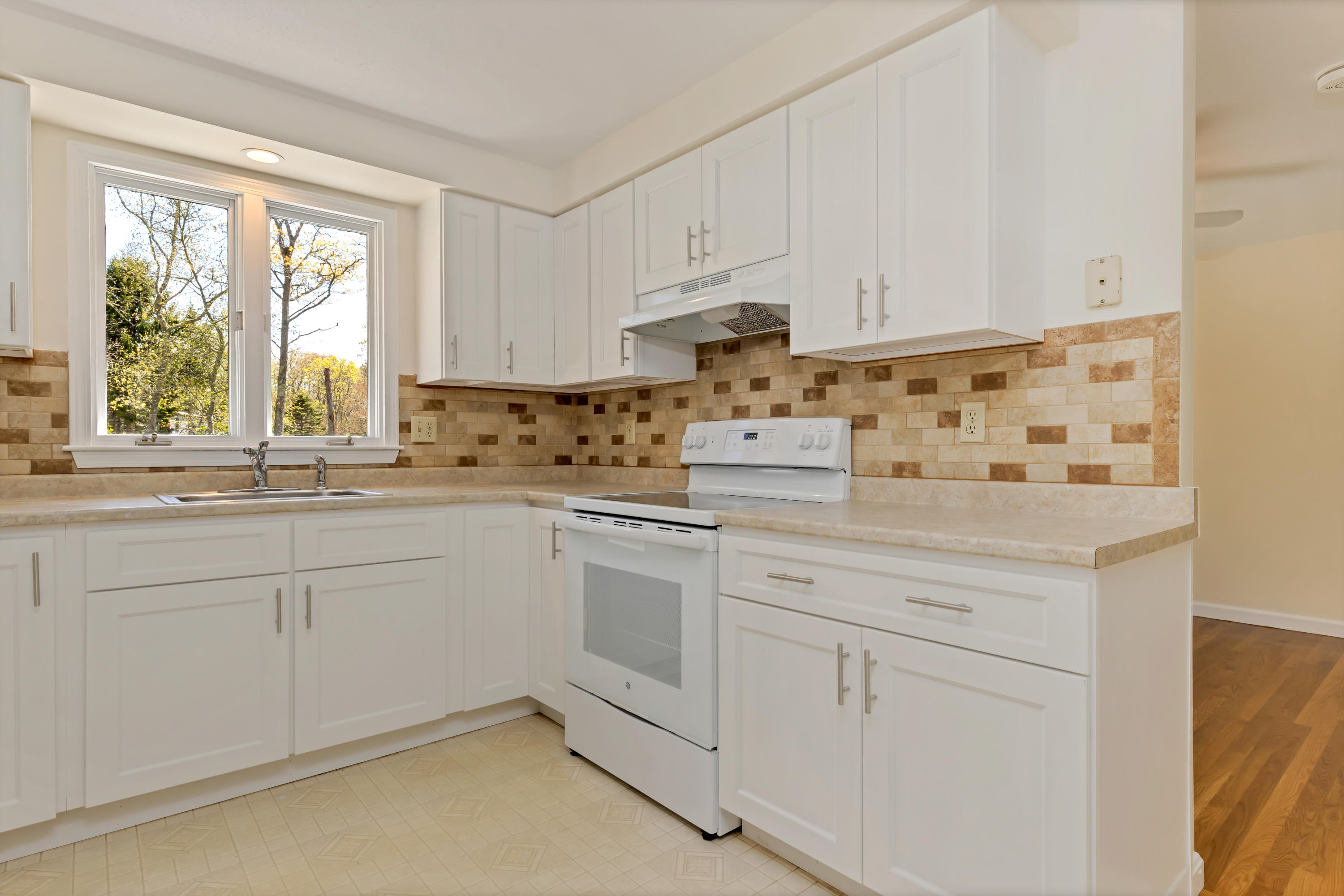 43 Valley Brook Road Centerville, MA 02632 - Photo 4 of 21 a kitchen with granite countertop white cabinets and white appliances