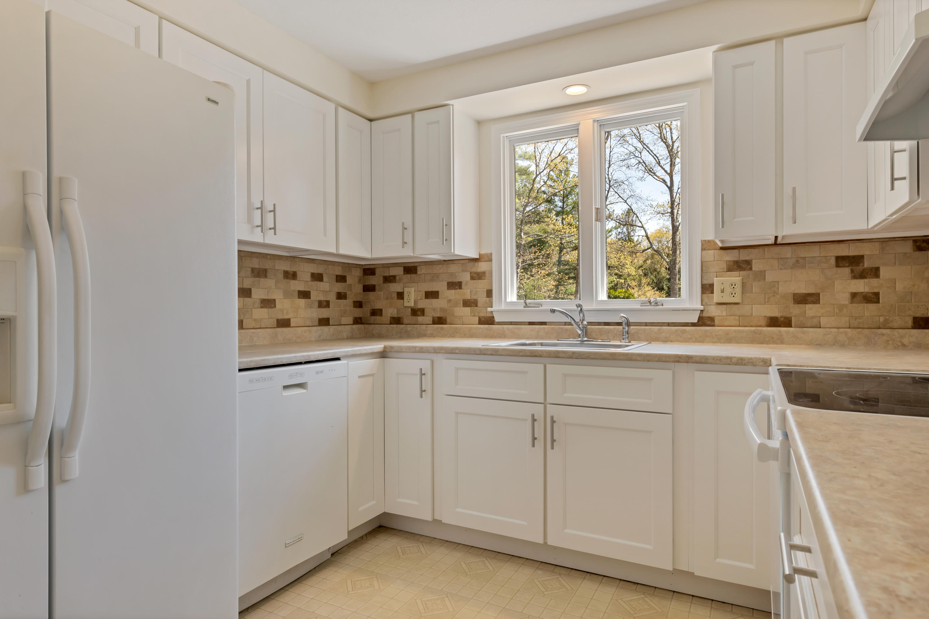 43 Valley Brook Road Centerville, MA 02632 - Photo 5 of 21 a kitchen with white cabinets and window