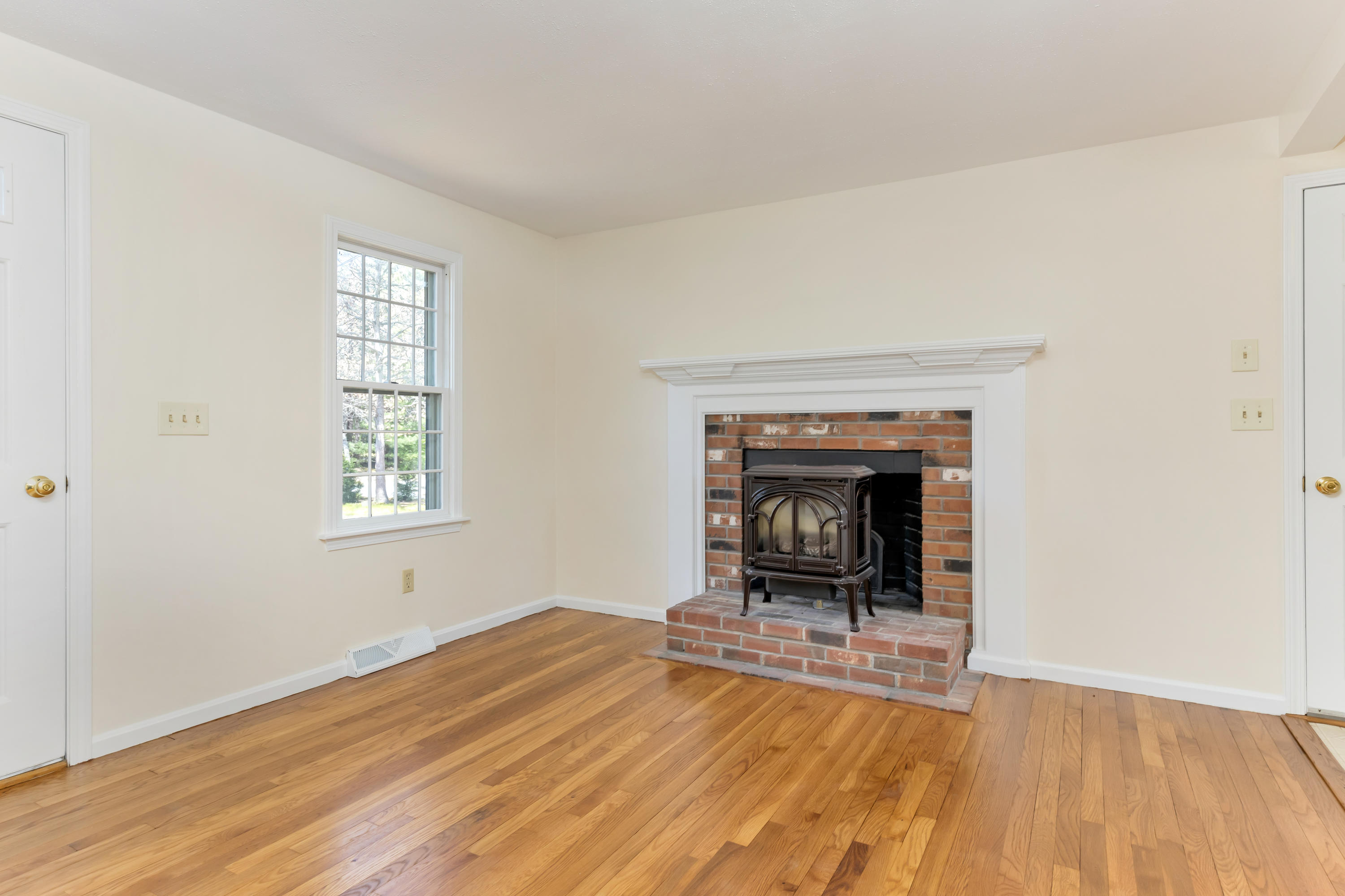 43 Valley Brook Road Centerville, MA 02632 - Photo 7 of 21 a view of a livingroom with a fireplace wooden floor and a window