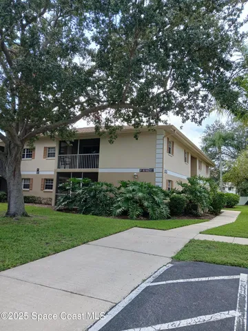a house that has a tree in front of it