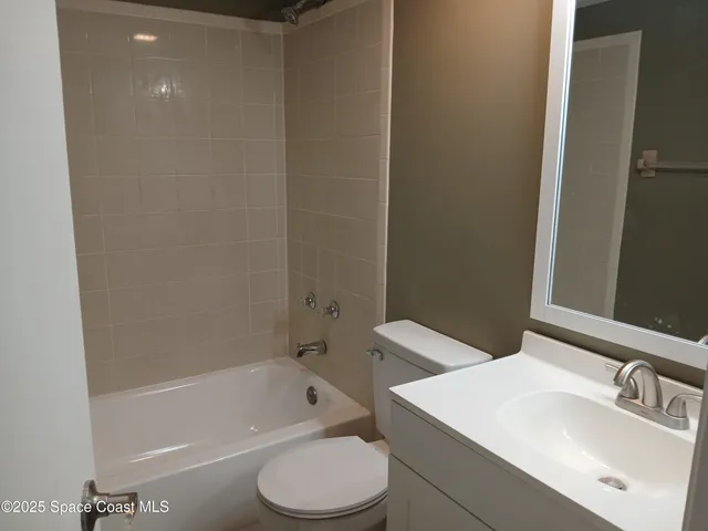 a bathroom with a sink a toilet and bathtub