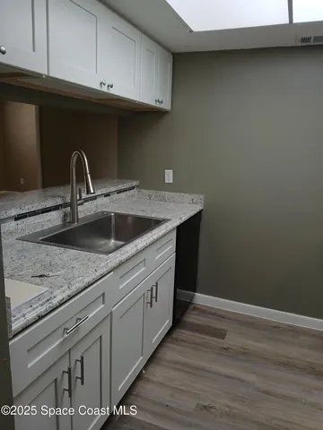 a kitchen with a sink and cabinets