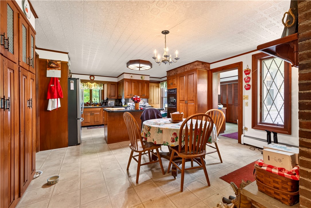 7780 Cold Springs Road Bath, NY 14810 - Photo 5 of 50 Rich wood cabinetry and patterned ceilings define this warm, open eat-in kitchen space.