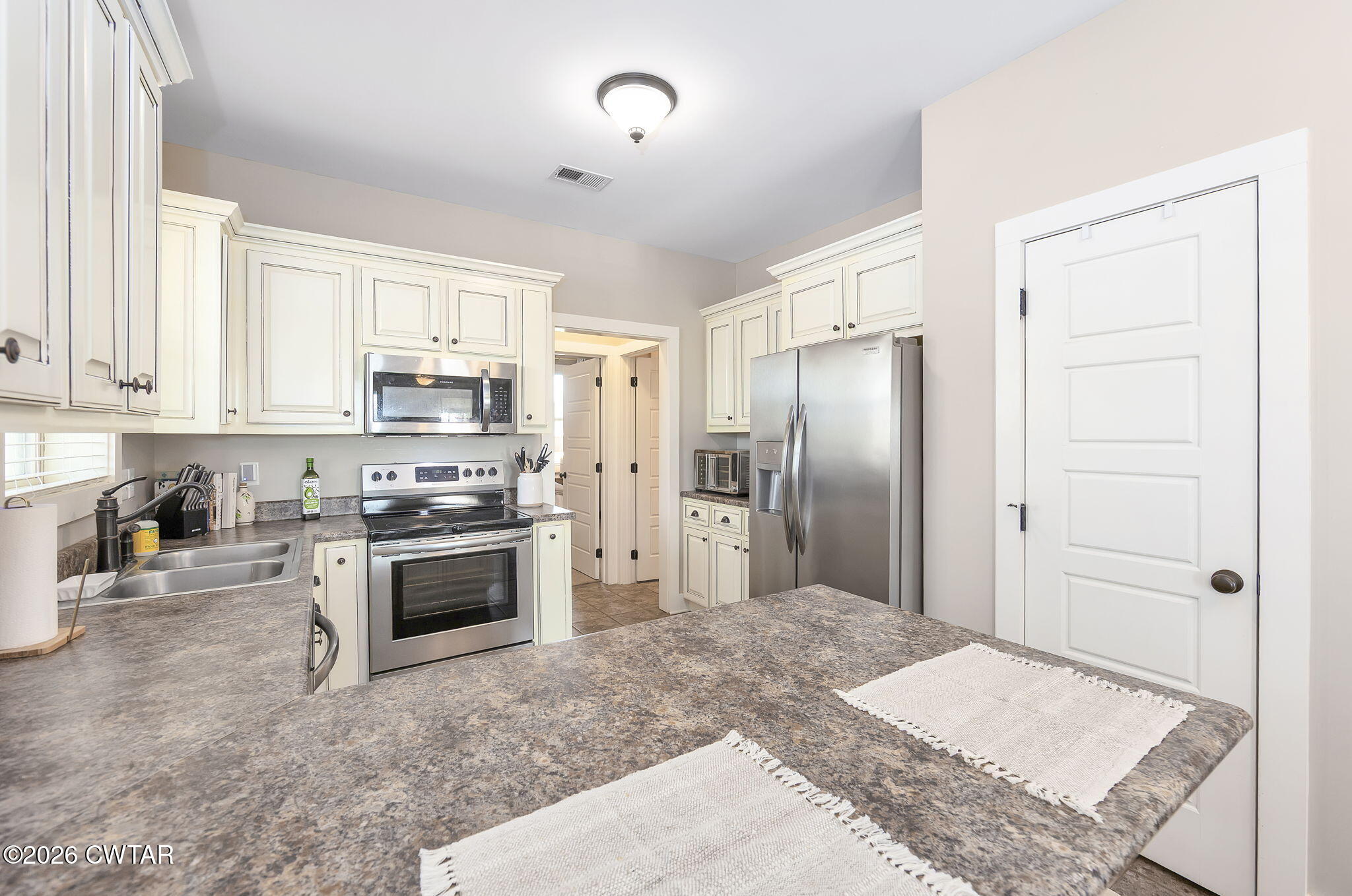223 Morgan Street Jackson, TN 38301 - Photo 11 of 39 a kitchen with stainless steel appliances granite countertop a refrigerator a stove and a sink